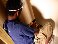 Derrick screwdriving in some drywall.