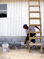 Keishaun shoveling up rocks in the yard.