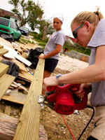 Katy + Alison cutting 2x4s.